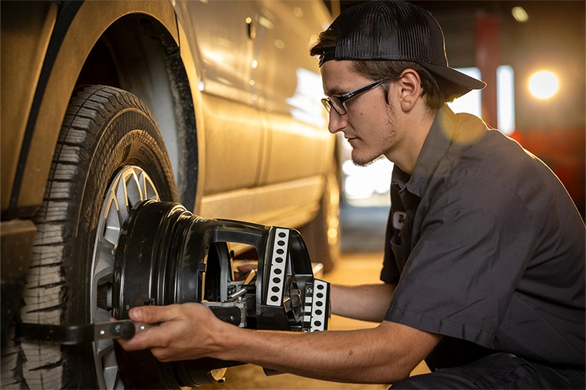 Mechanic working on a tire of a vehicle
