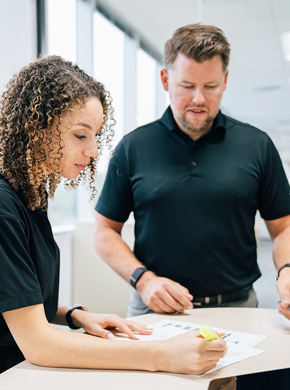 woman and man looking at forms for renting a vehicle in Davie